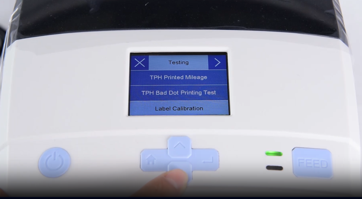 တစ်ခု close-up of a machine's digital interface showing a testing menu.